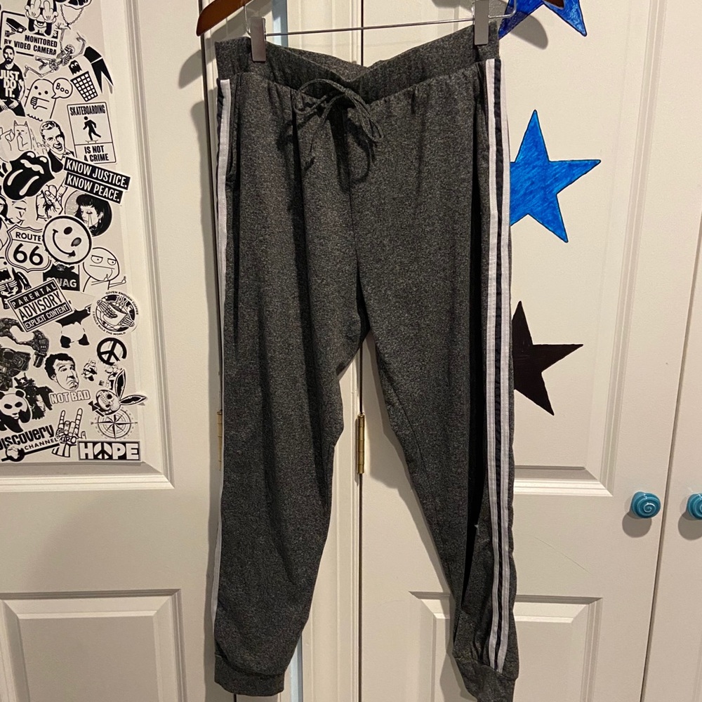 gray joggers with white stripes on the side